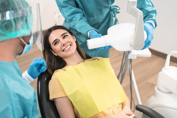 Woman smiling at dental assistant before exam