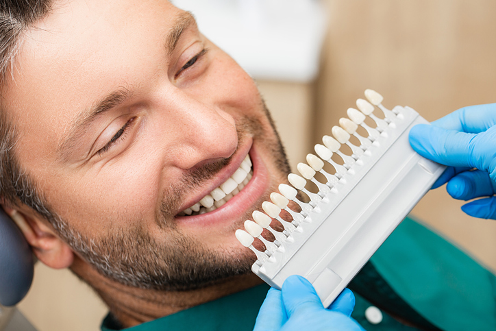 Man picking out dental veneer color