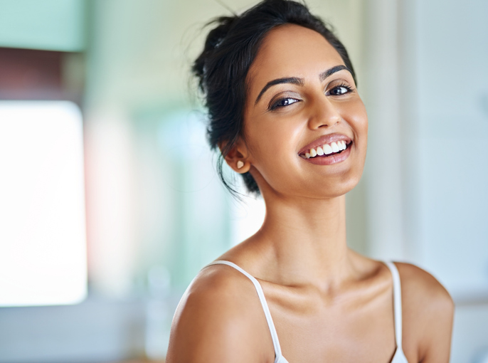 Woman tilting head and smiling